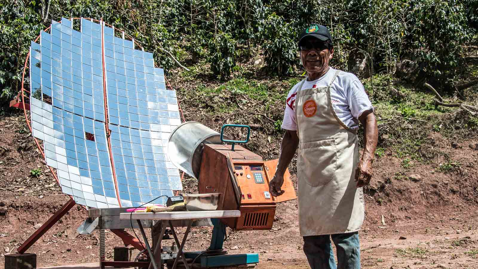 Farmer standing besides solar power machine