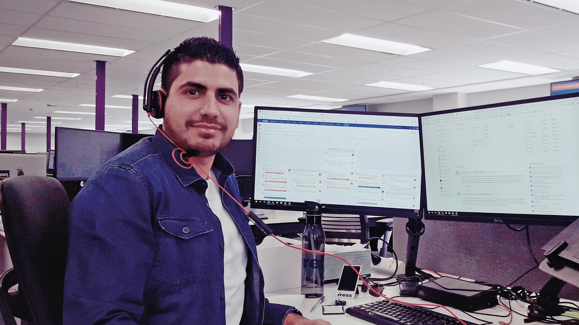 Employee posing at his office desk