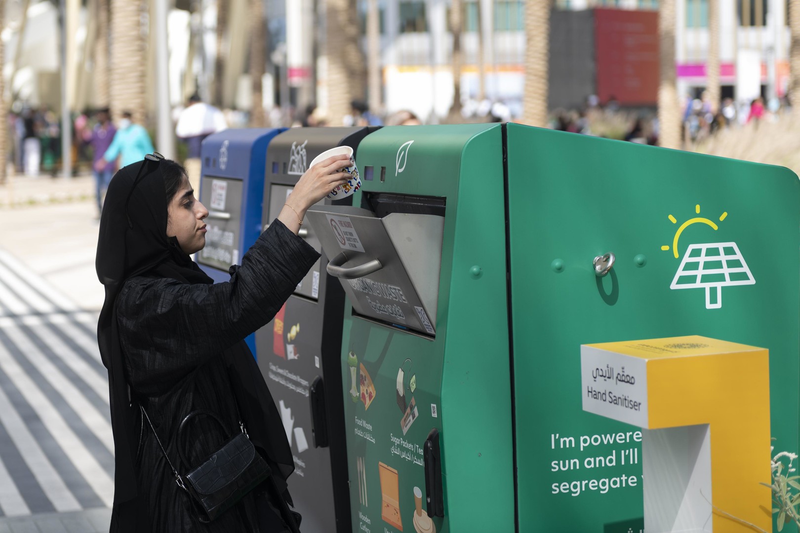 A visitor uses a Smart Bin by Dulsco